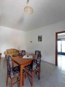 a dining room with a wooden table and chairs at Studio Poseidon in Leipsoi