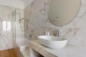 Baño blanco con lavabo y espejo en Villa sui Colli Bolognesi by Wonderful Italy, en Bolonia