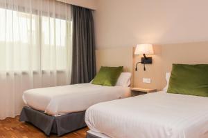 a hotel room with two beds and a window at Hotel Lauria in Tarragona