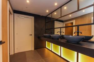 a bathroom with four sinks in a room at Hotel Lauria in Tarragona