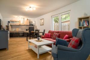 a living room with a red couch and a table at Ferienhaus Sternchen 3 in Schwarz