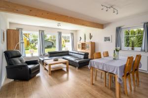 a living room with a couch and a table at Ferienhaus Spiekeroog- Müritz in Zielow