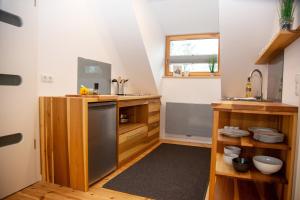 a kitchen with wooden cabinets and a stainless steel dishwasher at Ferienwohnung Am Ufer an der Müritz in Rechlin