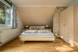 a bedroom with a bed and a stone wall at Ferienwohnung Seebusch in Schwarz