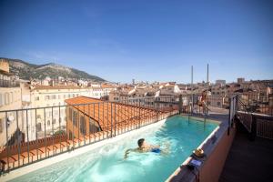 a man in a swimming pool on top of a building at L'Eautel Toulon Centre Port in Toulon
