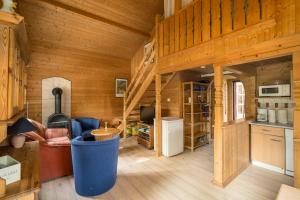 a wooden cabin with a kitchen and a living room at Ferienhaus Gerdi in Schwarz