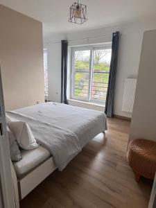 a bedroom with a large bed and a large window at Pina's Appartment in Namur