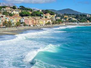 a view of a beach with a town in the background at CASA PRIMAVERA in Vado Ligure