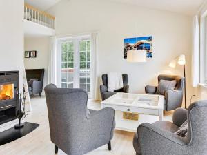 a living room with chairs and a fireplace at Holiday home Aabenraa LXIX in Aabenraa