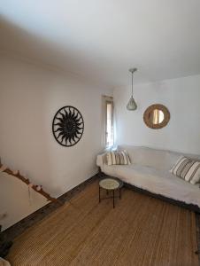 a living room with a white couch and a window at Appartment mit Charme am Strand in La Pared