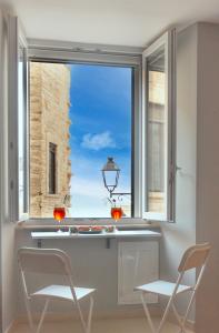 a window with a view of a building at Dimora nel Palazzo Ducale in Giovinazzo
