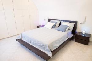 a bedroom with a large bed with two night stands at Dimora nel Palazzo Ducale with private parking in Giovinazzo