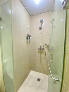 a bathroom with a shower with a glass door at Condo in Newport City Pasay near NAIA T3 AIRPORT MANILA in Manila