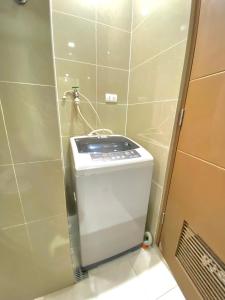 a small bathroom with a toilet in a stall at Condo in Newport City Pasay near NAIA T3 AIRPORT MANILA in Manila