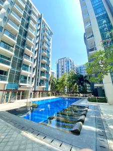 a swimming pool in a city with tall buildings at Condo in Newport City Pasay near NAIA T3 AIRPORT MANILA in Manila