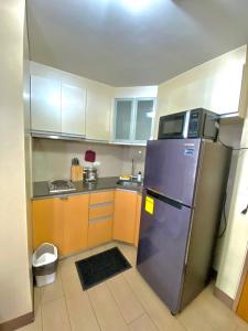 a kitchen with a refrigerator and a microwave at Condo in Newport City Pasay near NAIA T3 AIRPORT MANILA in Manila
