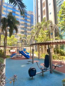 a playground with a slide and a swing at Condo in Newport City Pasay near NAIA T3 AIRPORT MANILA in Manila
