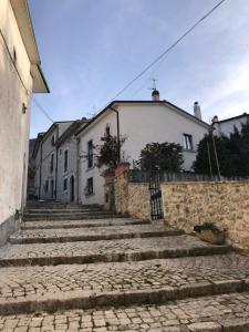 a building with stairs in front of a house at Casa Val di Rose in Civitella Alfedena