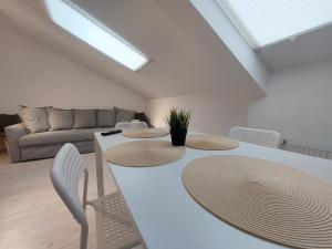 a living room with a white table and chairs at Key Apartments in Main Square in Braşov +81 photos