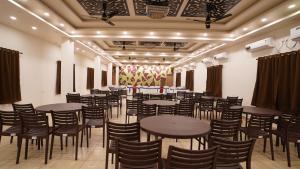 a large room with tables and chairs in it at Sher Bengal Beach Resort in Mandarmoni