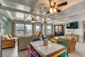 a living room with a ceiling fan and a table at Sunny Freeport Beach House Rental Near Shore in Freeport