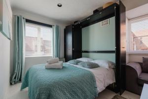 a bedroom with a large bed with a large mirror at Hullidays - Trinity Studio Apt. in Hull