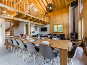 a large dining room with a long table and chairs at Chalet le Fauconnier in La Tzoumaz