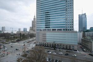 a view of a city with cars on a street at Urban Oasis Private Apartment with Palace of Culture View in Warsaw