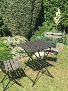 a picnic table and a bench in a garden at Apt. overlooking the castle Nižbor20km from Prague in Nižbor
