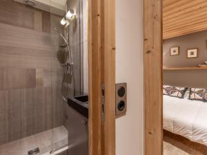 a bathroom with a shower with a glass door at Appartement spacieux avec wifi, parking, balcon Sud à 10 min des commodités - FR-1-694-33 in Val dʼIsère