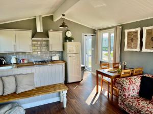 a kitchen with a refrigerator and a table at Brackenrigg Lodge in Felton