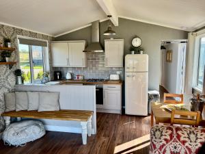 a kitchen with a white refrigerator and a table at Brackenrigg Lodge in Felton