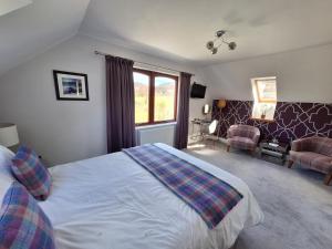 a bedroom with a bed and a living room at Lochview Guesthouse in Corran