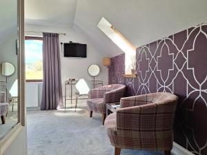 a living room with two chairs and a table at Lochview Guesthouse in Corran