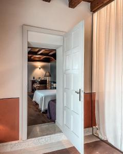 a door leading into a bedroom with a bed at Corielli B&B in Malo