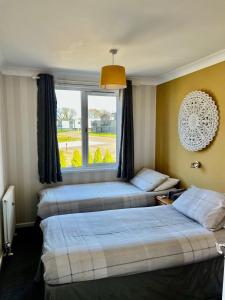 Ένα ή περισσότερα κρεβάτια σε δωμάτιο στο Brackenrigg Lodge