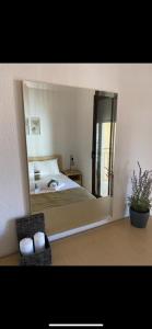 a bedroom with a bed and a large mirror at Dandelion Afytos in Afitos