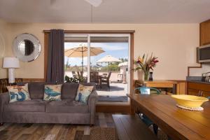 a living room with a couch and a table at Kihei Kai Nani 349, 1 BR, Top Floor, Pool, Wi-Fi, Sleeps 4 in Kihei