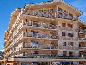 an apartment building with balconies on the side of it at Appartement élégant 3 pièces cabine avec wifi, skis aux pieds, en résidence de standing à Val-d'Isère - FR-1-694-218 in Val dʼIsère +9 photos
