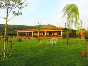 a resort with a green lawn and a building at Riva's Club Hotel in Polonezkoy