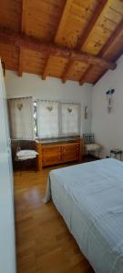 a bedroom with a large bed and wooden ceilings at Il nido di Agnese in Garda