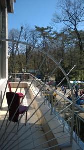 a chair sitting on a deck with a slide at Apartments Mavesa in Vrnjačka Banja