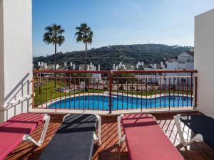 a balcony with a view of a swimming pool at 2174-Huge 3 bedrooms with terrace and pool in Manilva