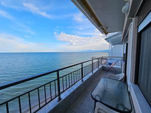 a balcony with a view of the ocean on a ship at Studio Just On The Beach in Paralia Katerinis