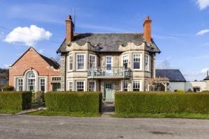 a large house with a balcony on the front of it at The Agents House, Bed & Breakfast in Hay-on-Wye