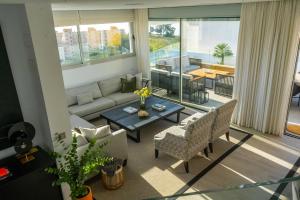 a living room with a couch and a table at Villa Palm Beach - Incredible villa with 5 rooms, amazing sea view and private pool in Fuengirola