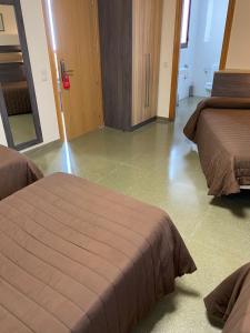 Postel nebo postele na pokoji v ubytování Hostal Meson Pepa