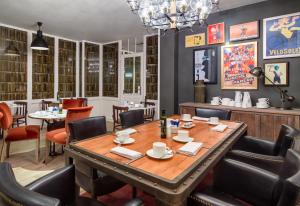 a dining room table with chairs and plates on it at Boutique Hotel H10 Montcada in Barcelona
