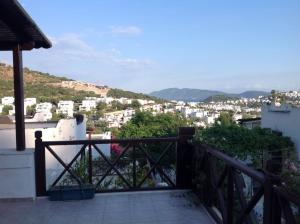 a balcony with a view of a city at Cheerful Bodrum Home in Bodrum City