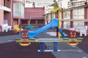 a playground with a blue slide on a balcony at Ferrobus Duplex in Cullera